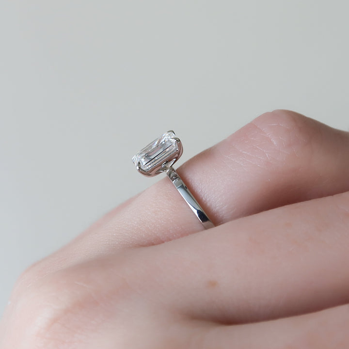 The Estella Emerald Lab Diamond Moissanite Engagement Ring *Shown with 1.5 ct #material_white