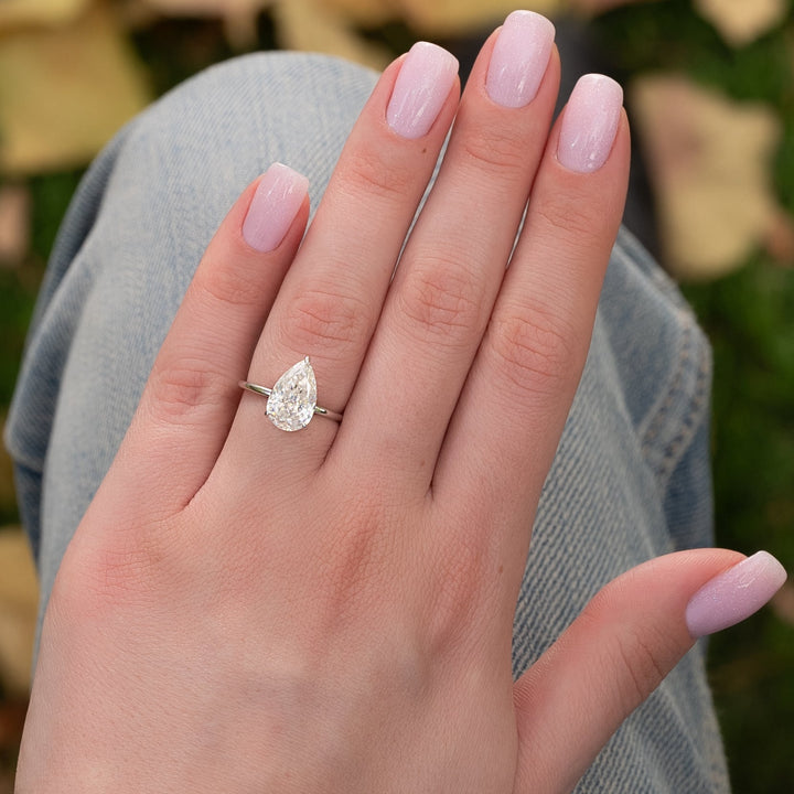 The Navy Pear Lab Diamond Moissanite Engagement Ring *Shown with 3 ct #material_white