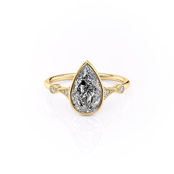 Gold ring with a large teardrop-shaped diamond on a white background#material_gold