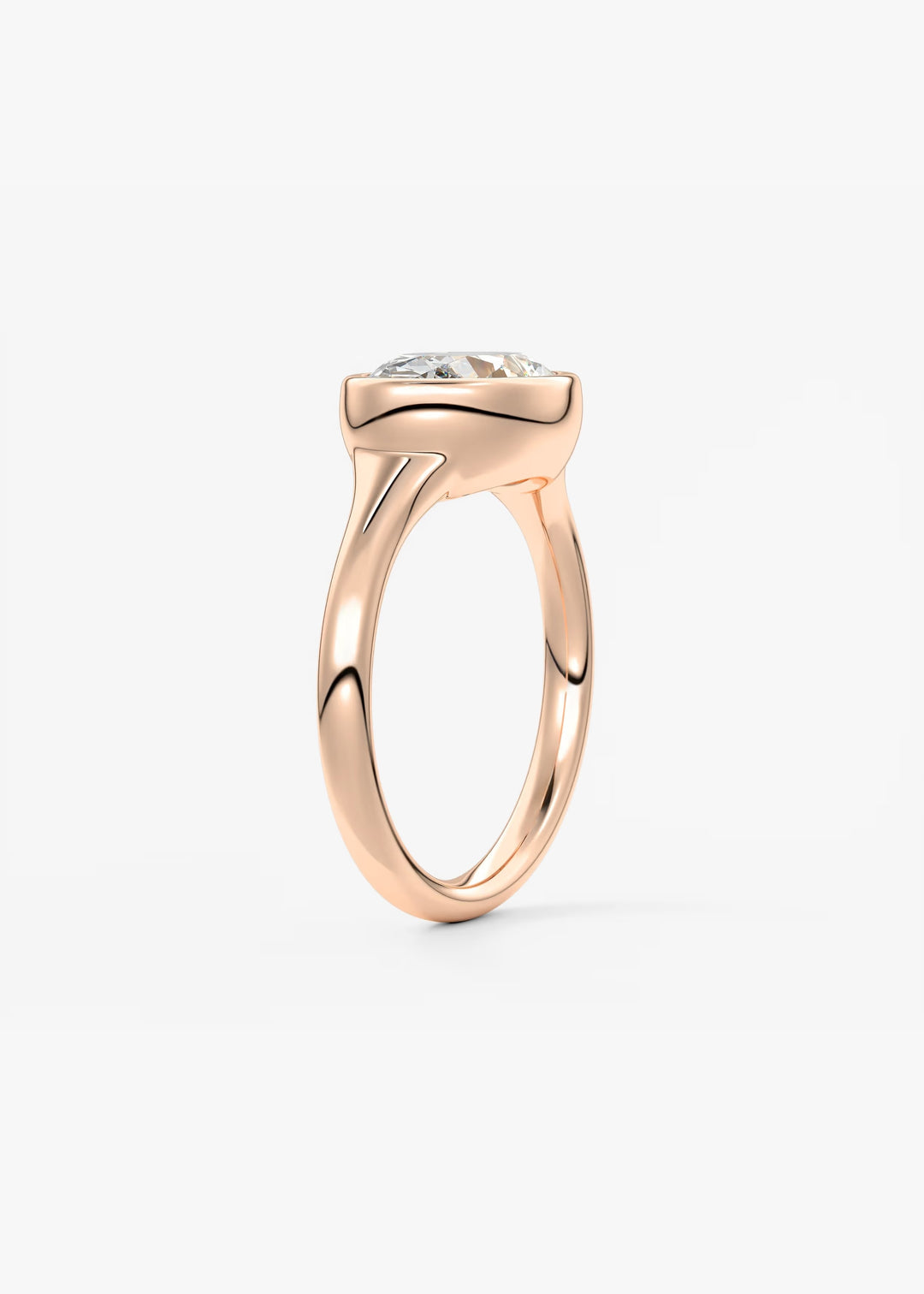 A rose gold solitaire ring with a clear round-cut gemstone in a prong setting, shown from a side profile view against a clean white background.#material_rose
