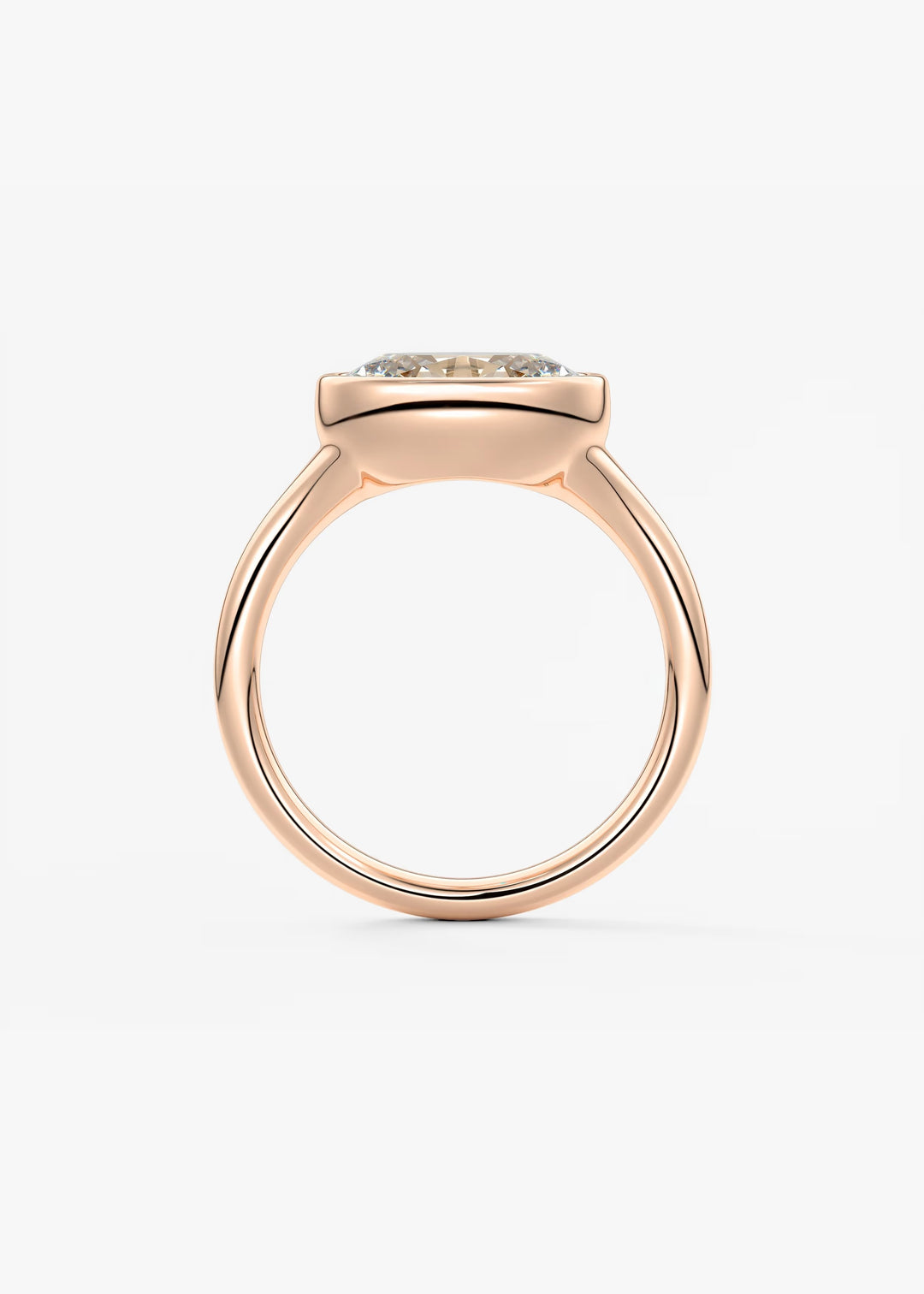 A rose gold ring with a square bezel setting holding a small round clear gemstone, shown from a top-down view on a light gray background.#material_rose