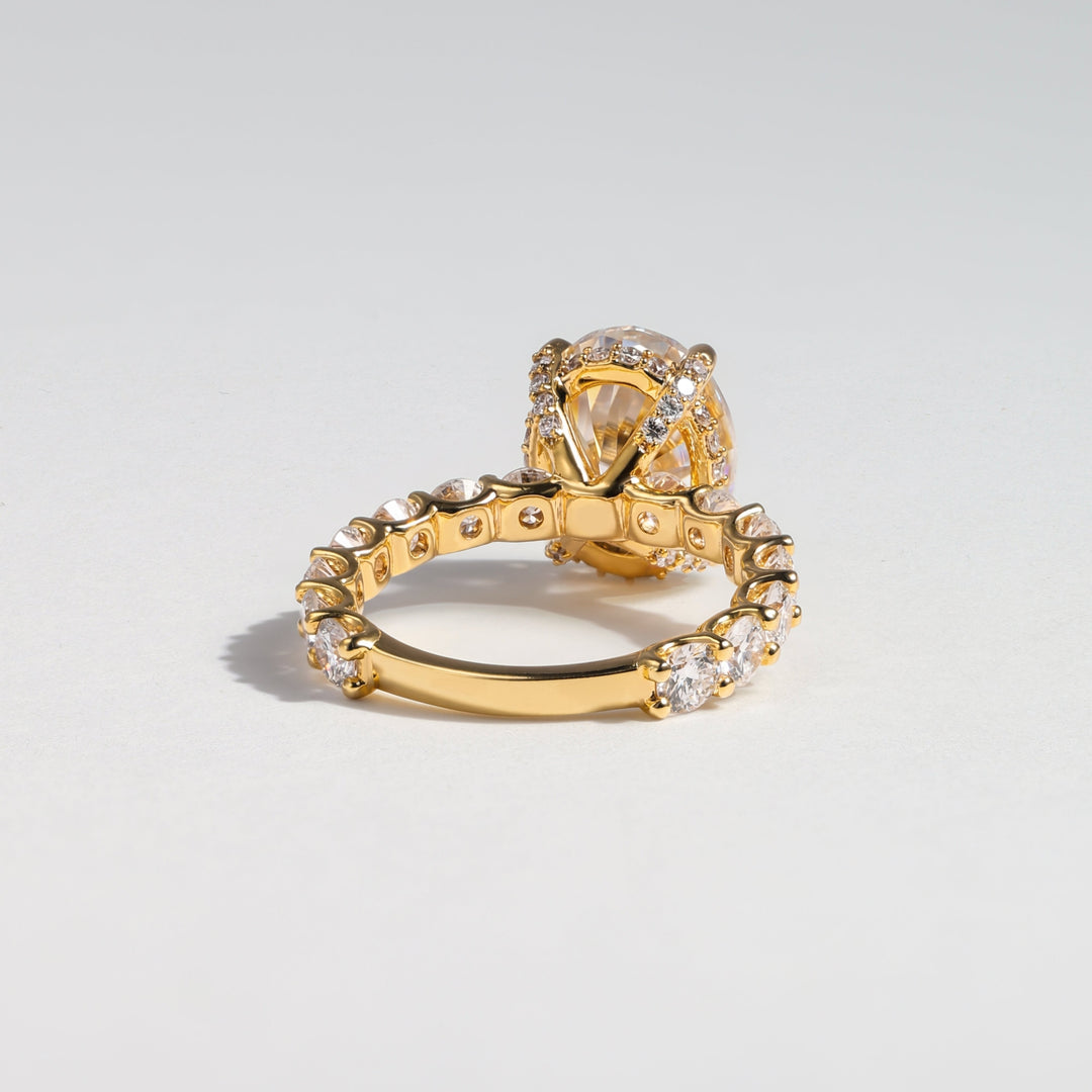 A gold ring with a pavé-set clear crystal crown and a matching crystal-accented band, photographed on a clean light gray background #material_gold