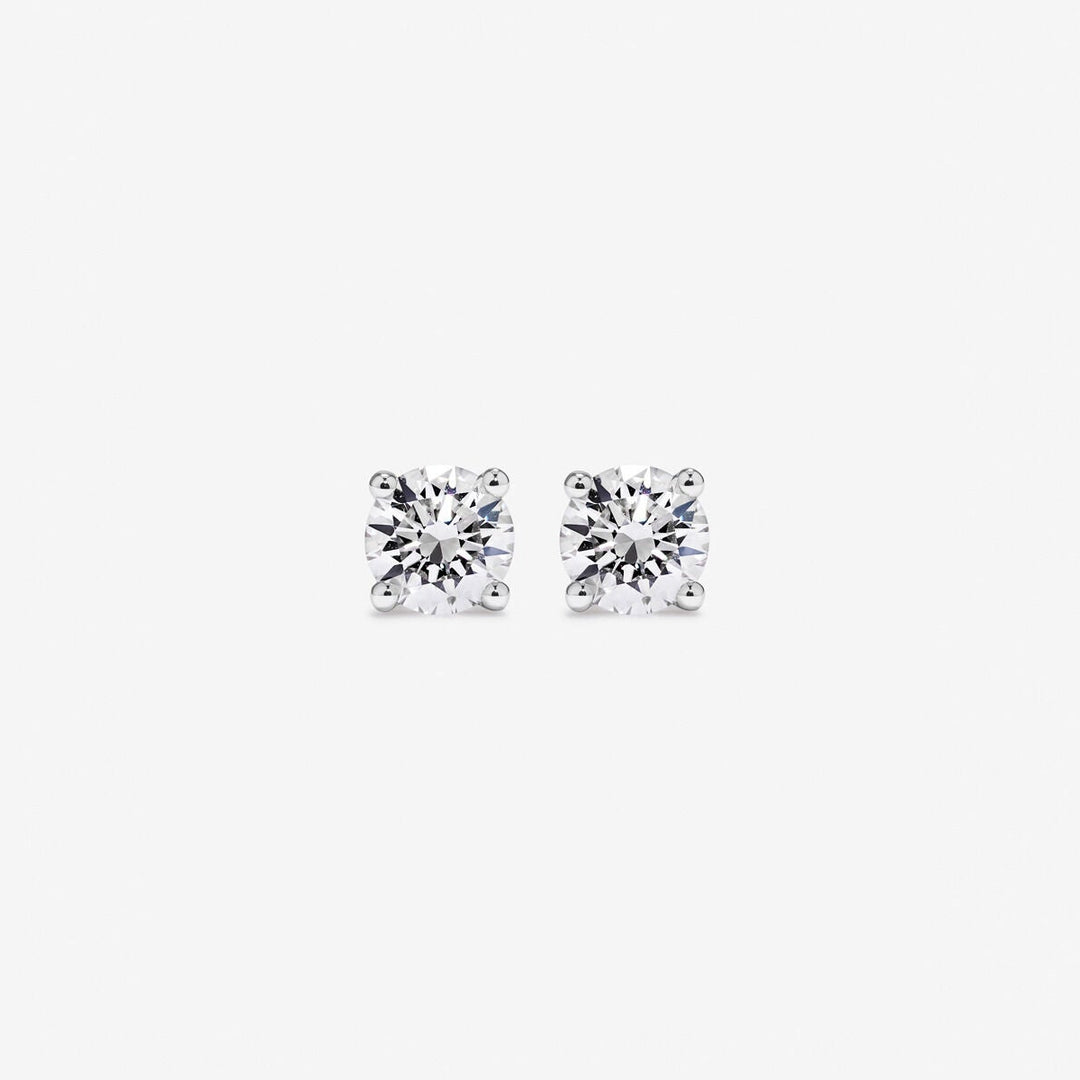 Pair of diamond stud earrings on a white background