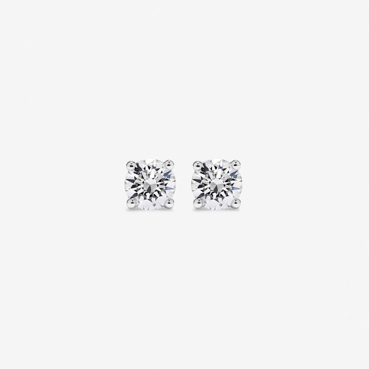 Pair of diamond stud earrings on a white background