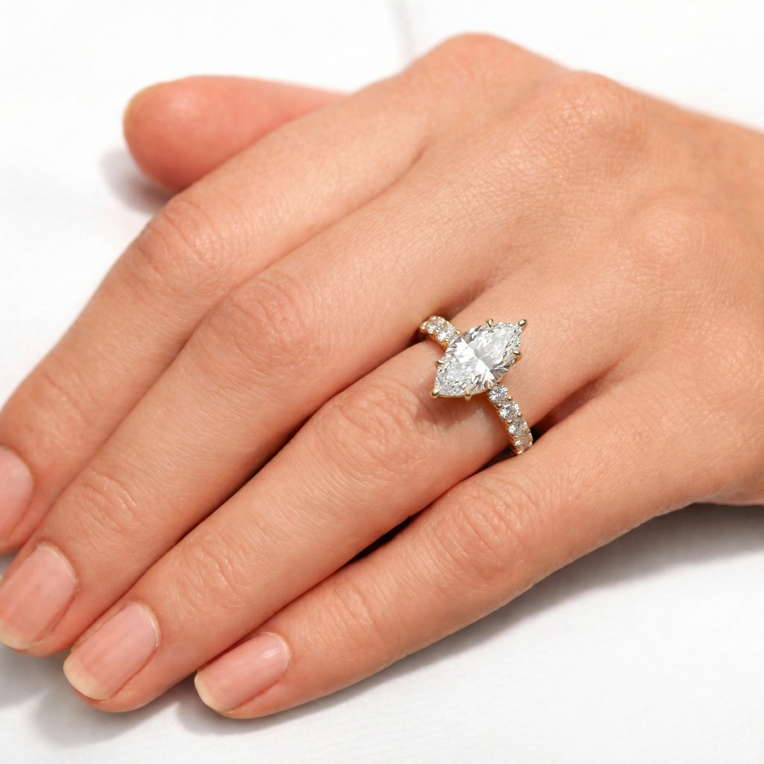 Diamond ring on a hand against a white background #material_gold