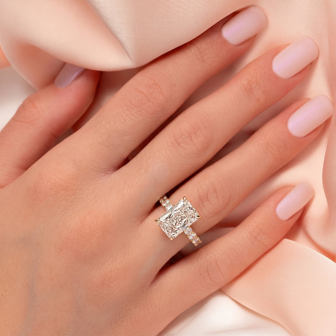 Close-up of a hand wearing a diamond ring with another ring on a soft background #material_gold