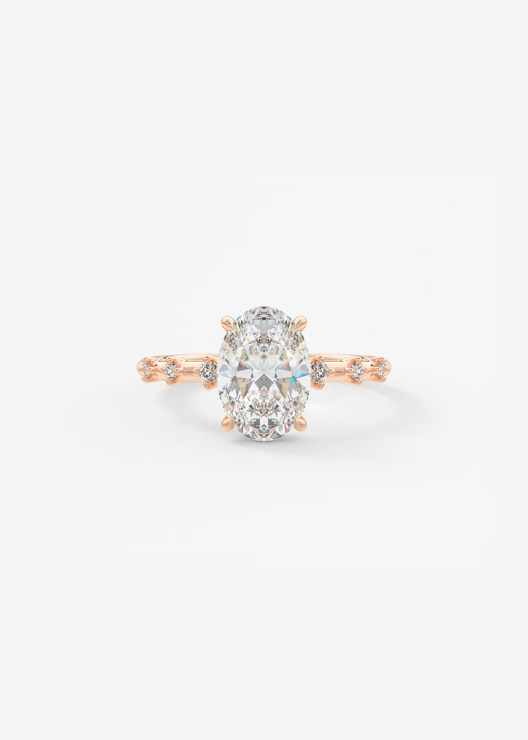 A rose gold engagement ring featuring a large oval-cut center stone and small accent stones along the band, set against a plain white background.#material_rose
