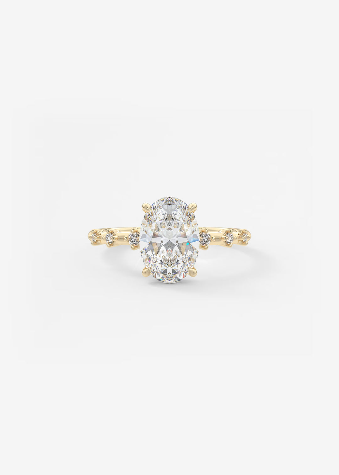 A yellow gold engagement ring featuring a large oval-cut center stone and small accent stones along the shoulders, set against a plain white background.#material_gold