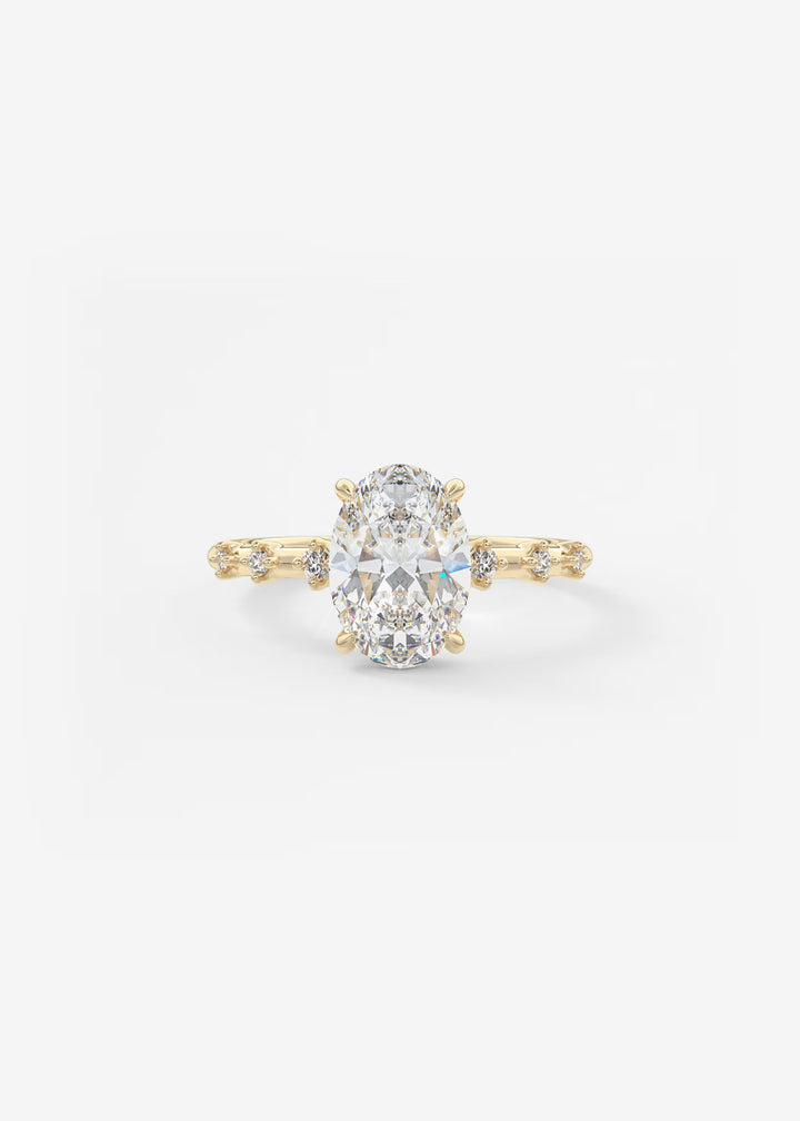 A yellow gold engagement ring featuring a large oval-cut center stone and small accent stones along the shoulders, set against a plain white background.#material_gold
