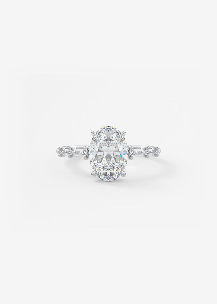 A silver-toned diamond engagement ring featuring a large oval-cut center stone with smaller diamonds along the shoulders, set against a plain white background.#material_white