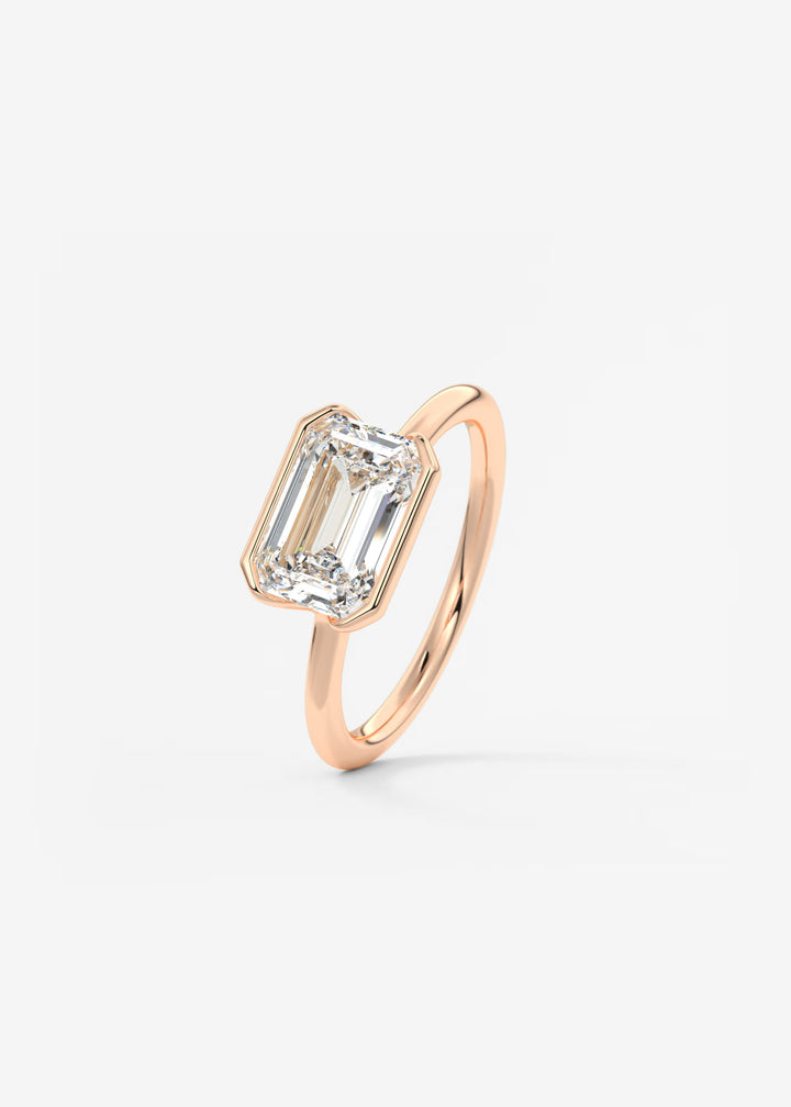 The Colette Horizon Signature East West Emerald Cut Half Bezel Engagement Ring#material_rose