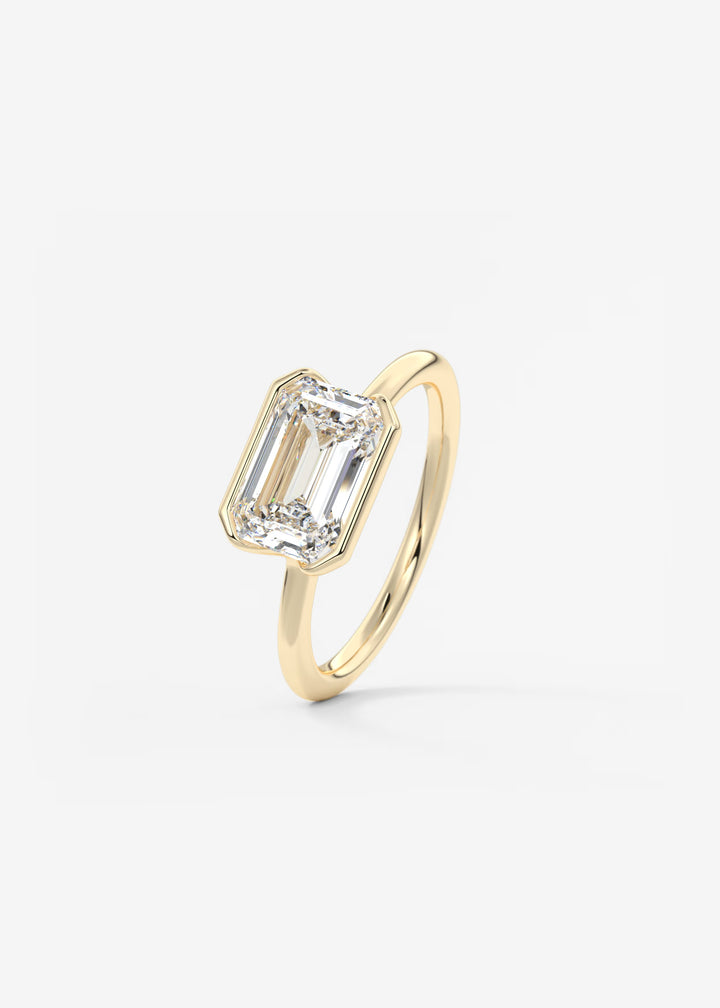 The Colette Horizon Signature East West Emerald Cut Half Bezel Engagement Ring#material_gold