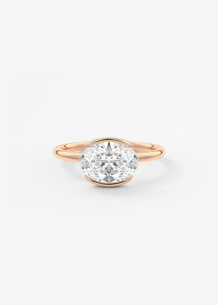 A rose gold engagement ring featuring a round brilliant-cut diamond set in a prong setting, centered on a clean white background.#material_rose