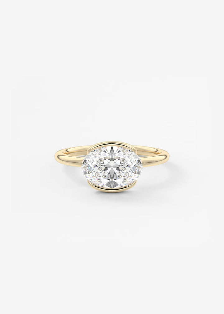 A yellow gold engagement ring featuring a large round brilliant-cut diamond center stone in a prong setting, shown on a clean white background.#material_gold