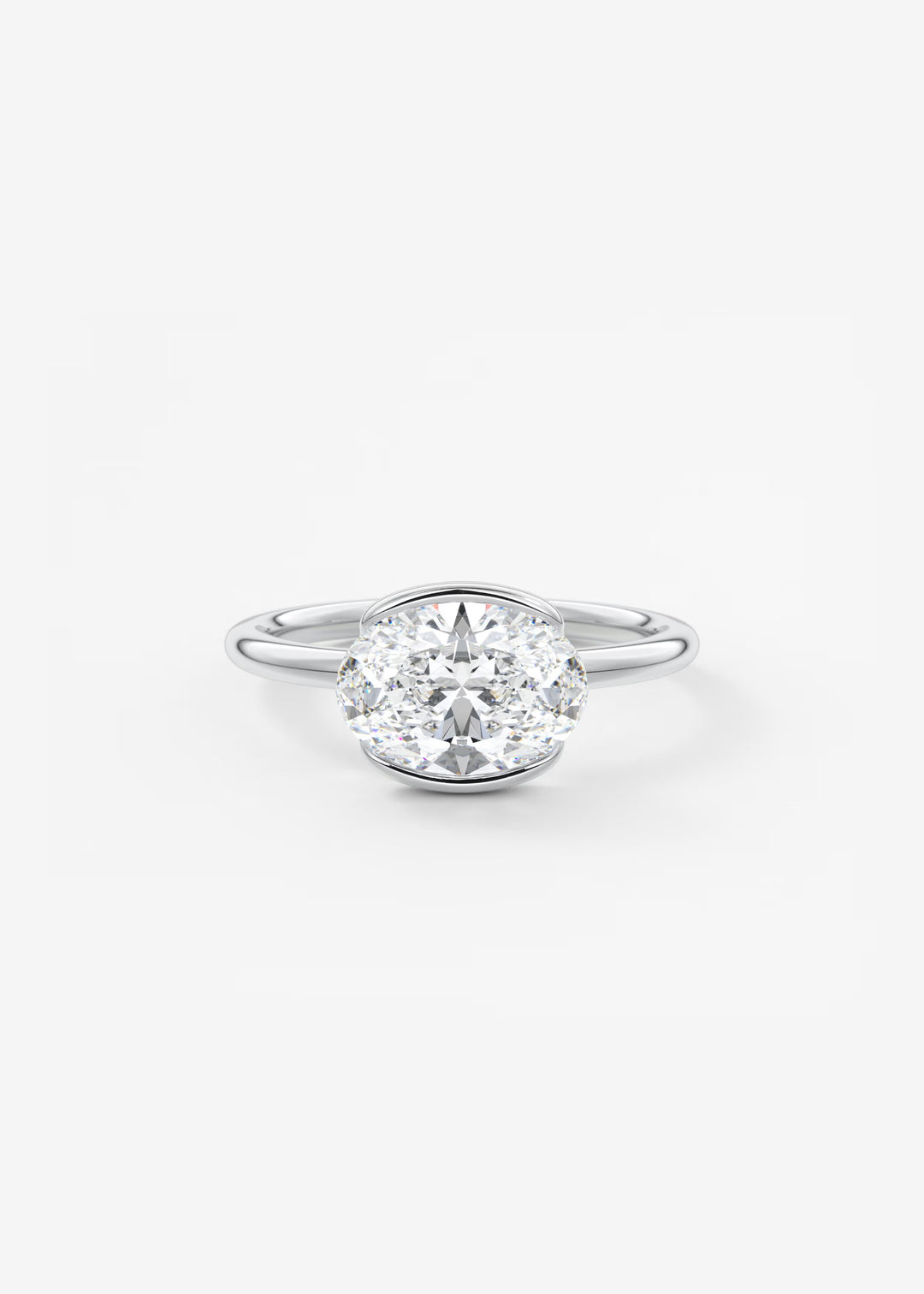 A classic diamond engagement ring with a round brilliant-cut center stone in a four-prong setting on a polished silver band, shown against a clean white background.#material_white