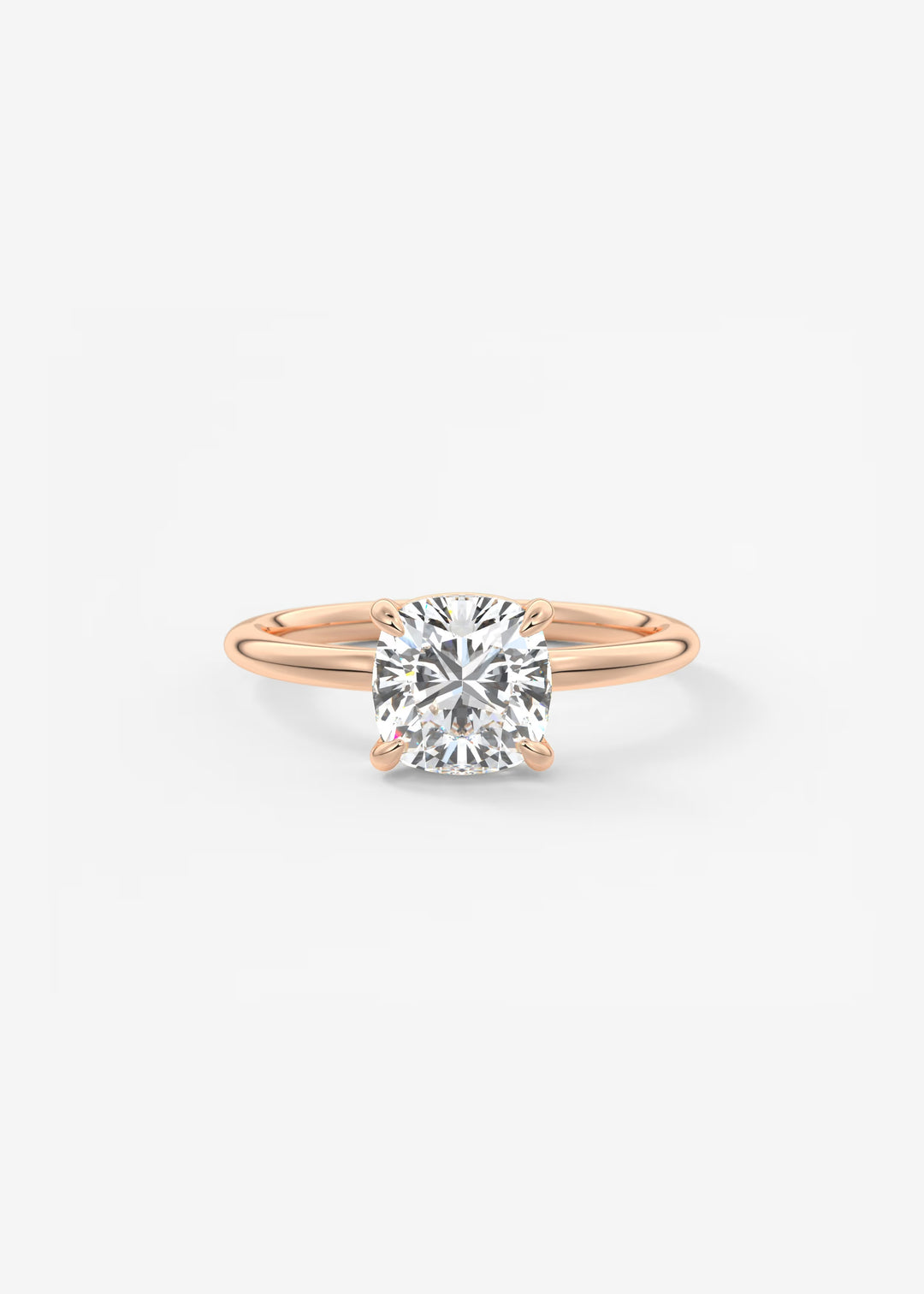 A rose gold solitaire engagement ring with a round brilliant-cut diamond center stone, shown on a clean white background.#material_rose