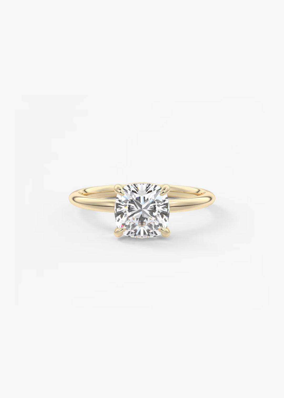 A yellow gold solitaire engagement ring with a round brilliant-cut diamond, shown on a clean white background.#material_gold