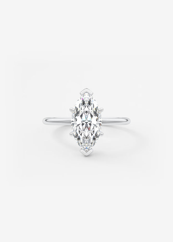 A silver-tone ring featuring a marquise-cut clear gemstone in a prong setting, centered on a plain light gray background.#material_white