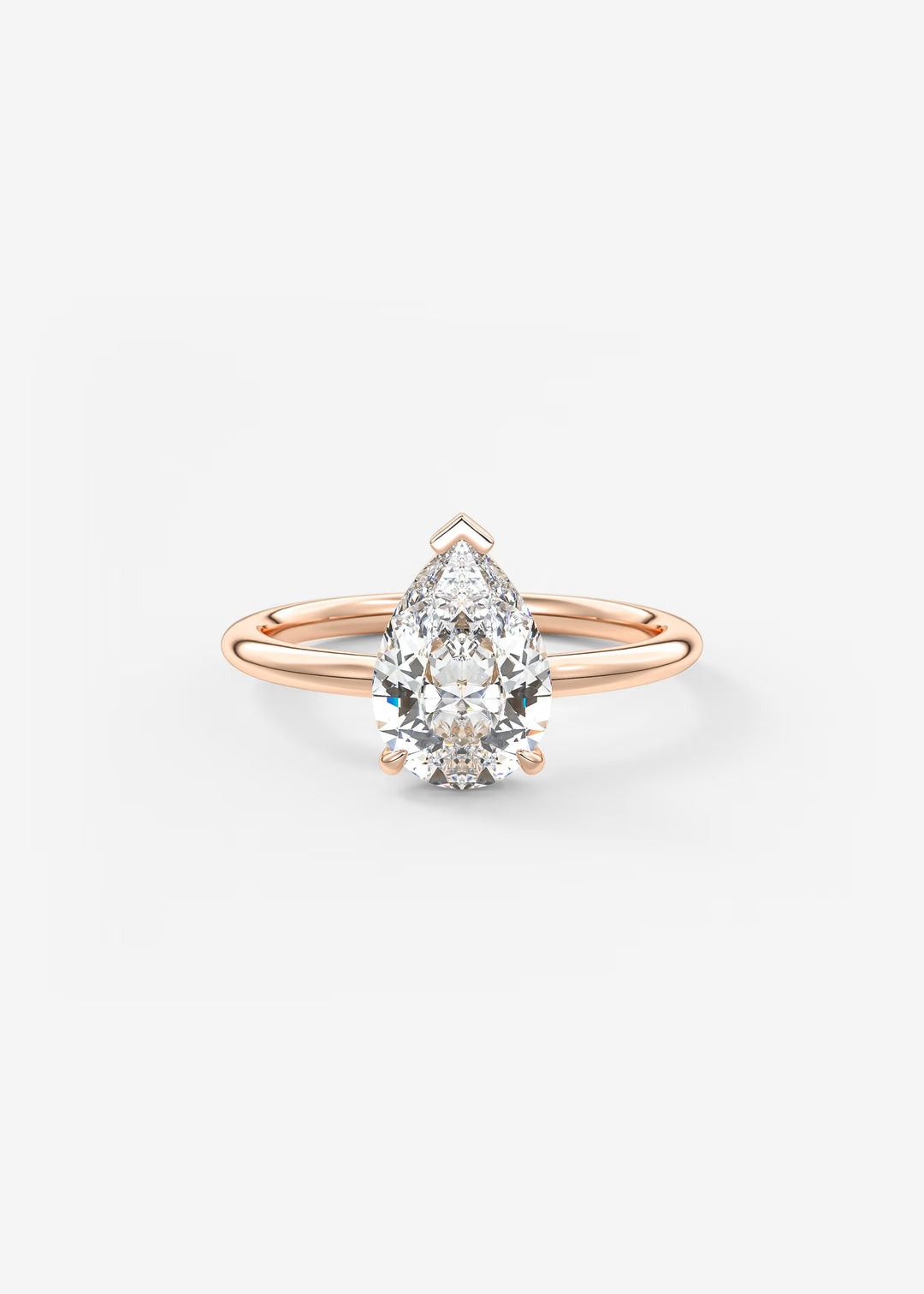 A pear-cut diamond engagement ring in a rose gold setting, centered on a clean white background.#material_rose
