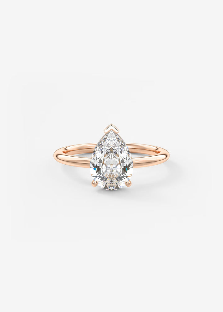 A pear-cut diamond engagement ring in a rose gold setting, centered on a clean white background.#material_rose