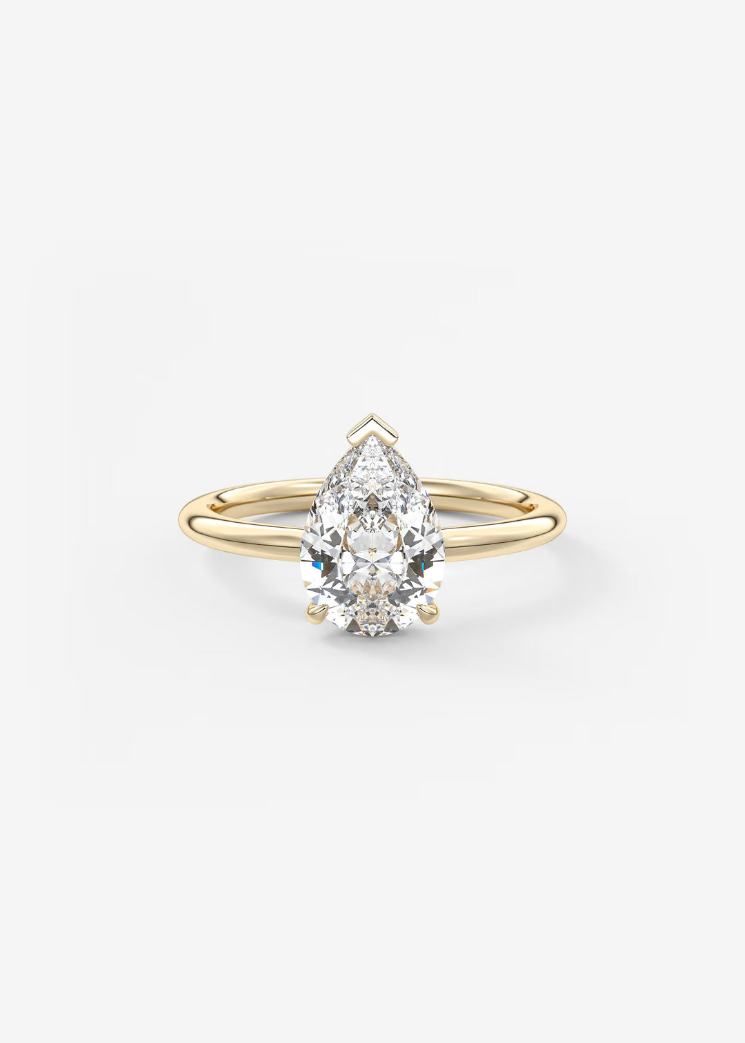 A pear-cut diamond engagement ring with a yellow gold band, shown on a clean white background.#material_gold