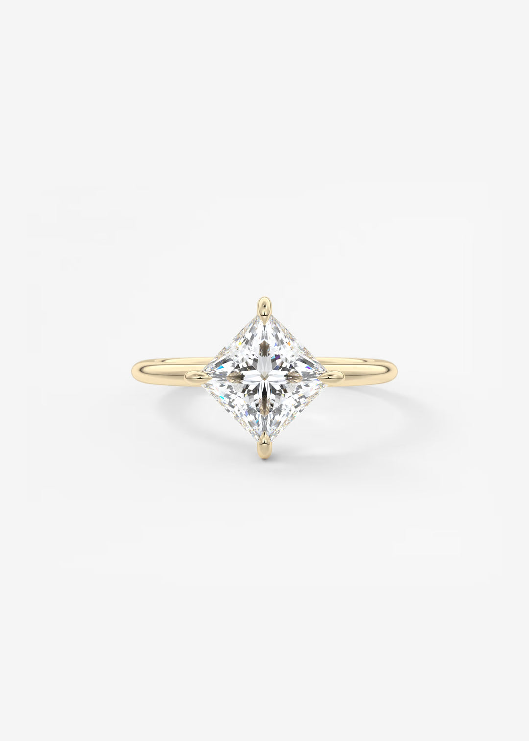 A yellow gold ring featuring a large, brilliant-cut diamond in a four-prong setting, centered on a clean white background.#material_gold