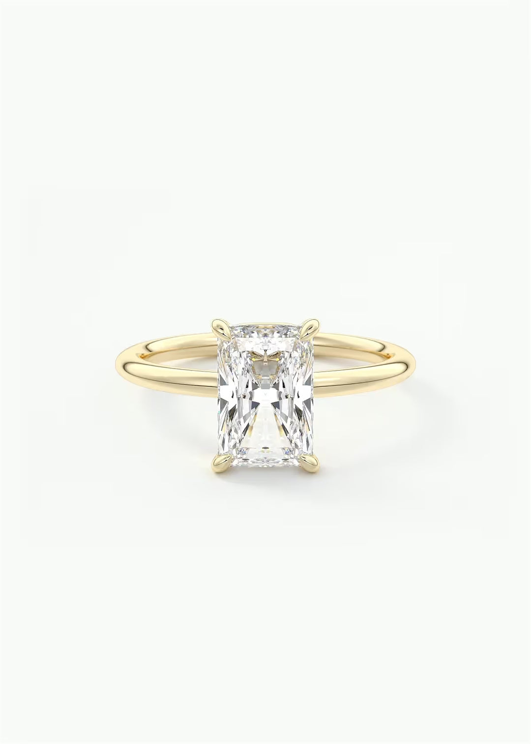 A yellow gold ring featuring a large rectangular emerald-cut clear gemstone in a four-prong setting, shown against a plain white background.#material_gold
