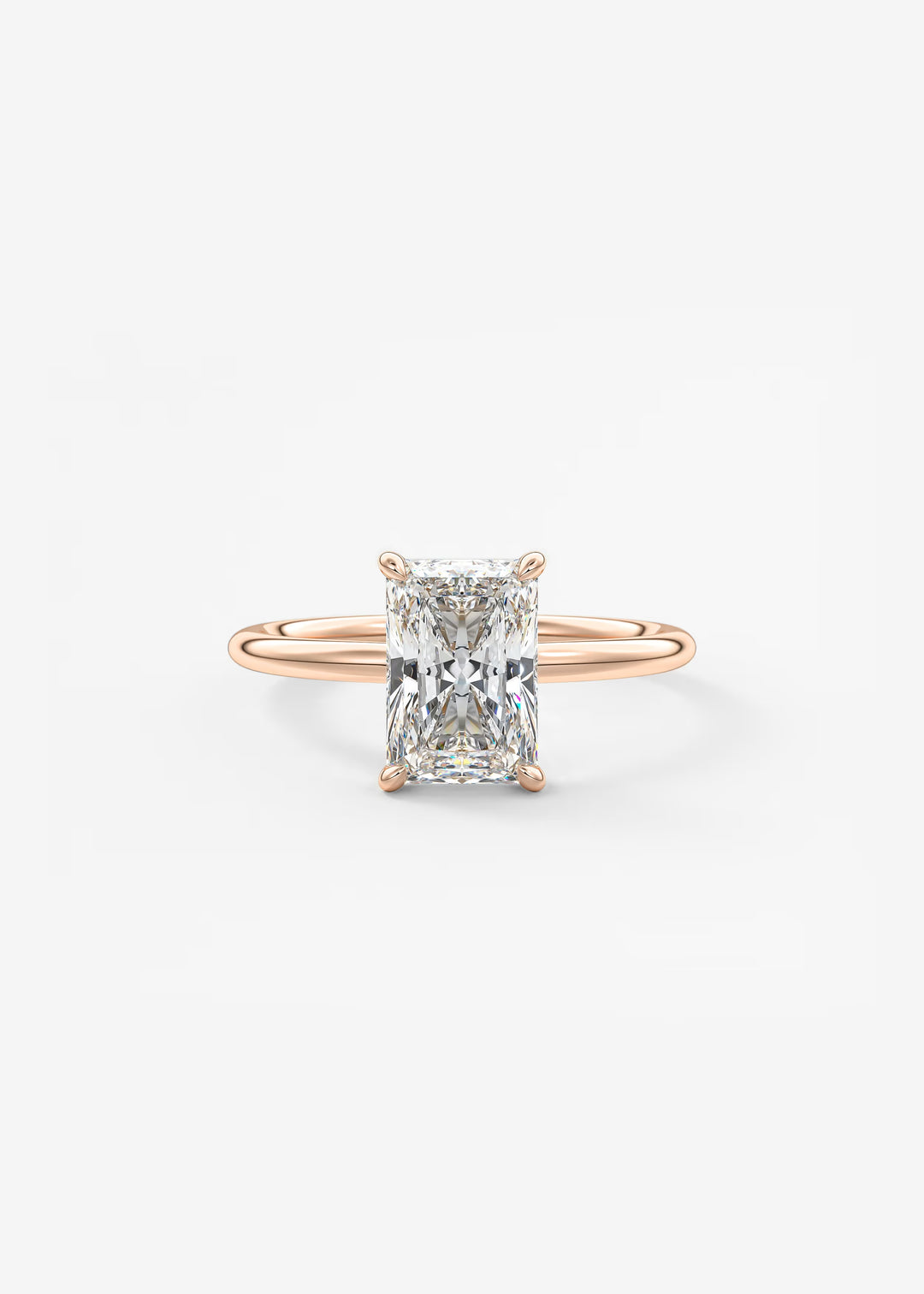 A rose gold engagement ring featuring a rectangular radiant-cut diamond center stone in a four-prong setting, shown on a clean white background.#material_rose