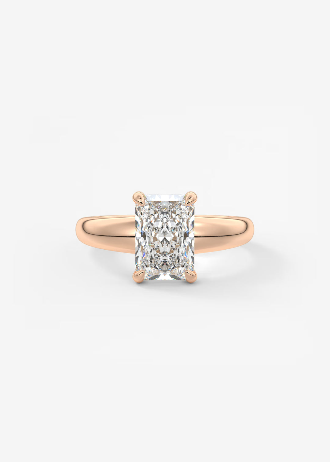 A rose gold solitaire ring featuring a large rectangular radiant-cut diamond, set against a clean white background.#material_rose