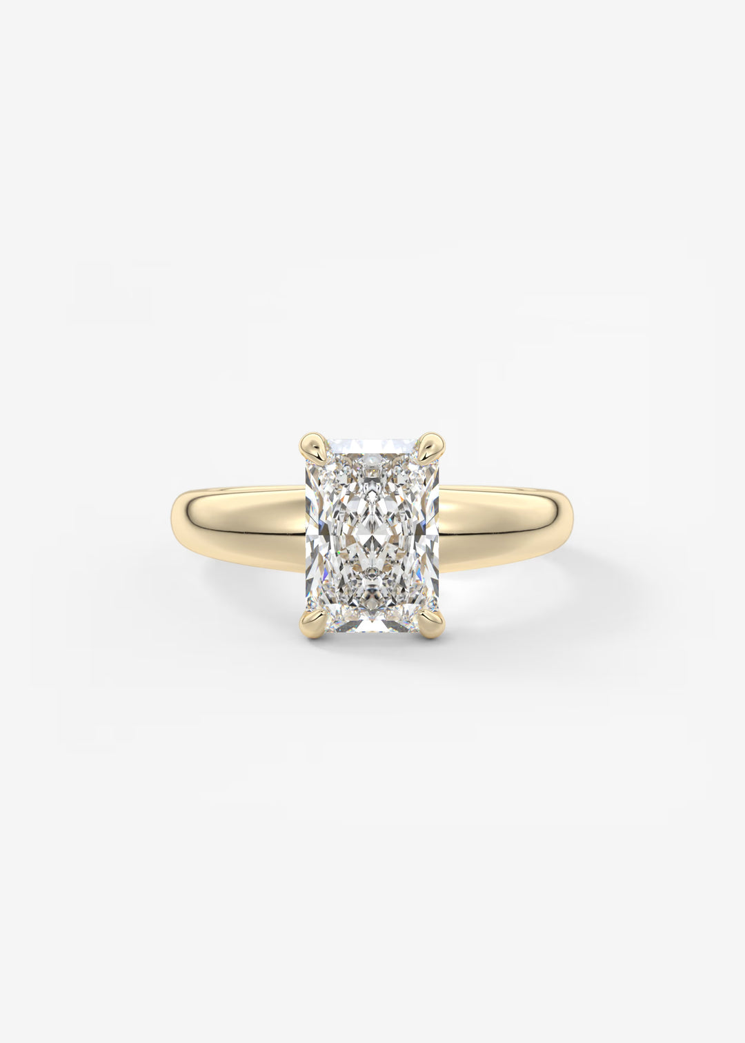 A yellow gold solitaire ring featuring a large rectangular radiant-cut diamond, set against a clean white background.#material_gold