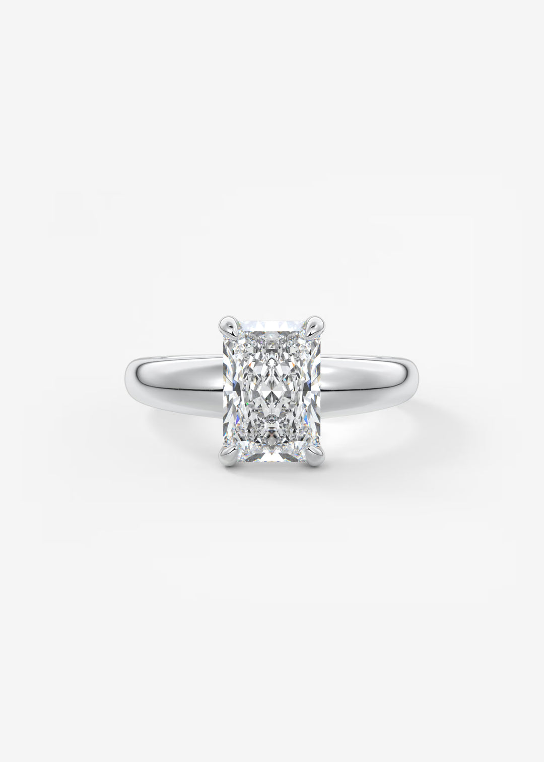 An engagement ring featuring a rectangular radiant-cut diamond set in a polished silver-colored band, centered on a clean white background.#material_white