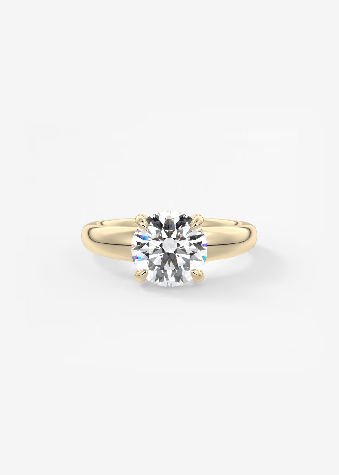 A classic solitaire engagement ring featuring a round brilliant-cut diamond set in a yellow gold four-prong band, centered on a clean white background.#material_gold