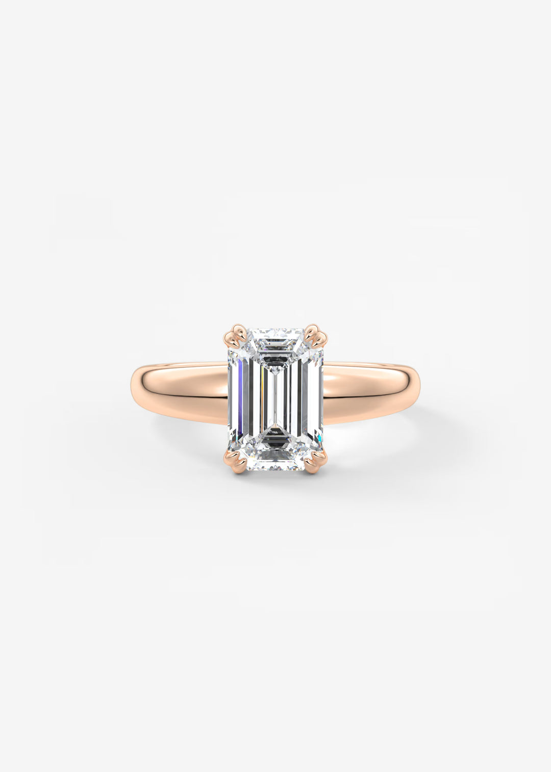 A rose gold ring with a large emerald-cut clear gemstone, set against a clean white background.#material_rose
