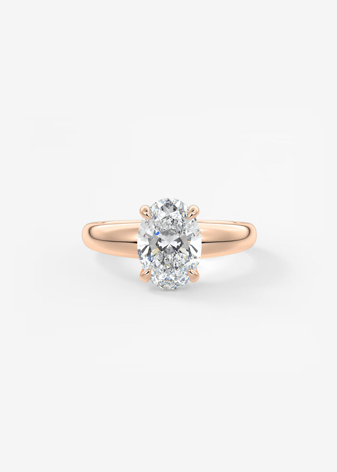 A rose gold engagement ring featuring a large oval-cut diamond in a four-prong setting, shown on a clean white background.#material_rose