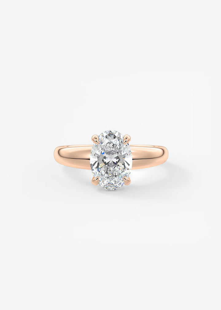 A rose gold engagement ring featuring a large oval-cut diamond in a four-prong setting, shown on a clean white background.#material_rose