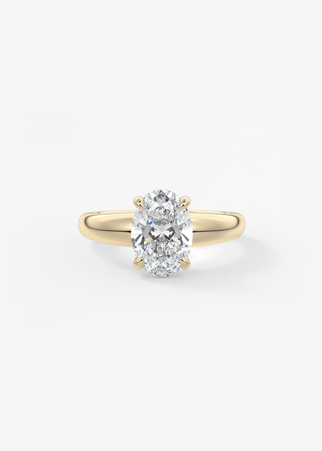 An oval-cut diamond engagement ring with a yellow gold band, shown on a clean white background.#material_gold