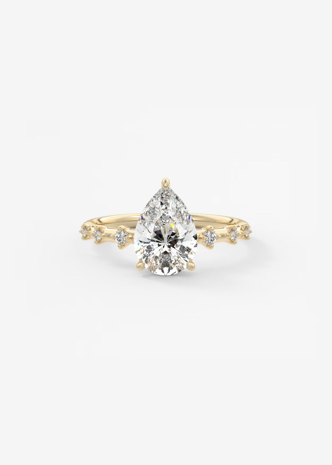 A pear-cut diamond engagement ring in yellow gold, featuring a central pear-shaped diamond and smaller diamonds along the shoulders of the band, set against a clean white background.#material_gold