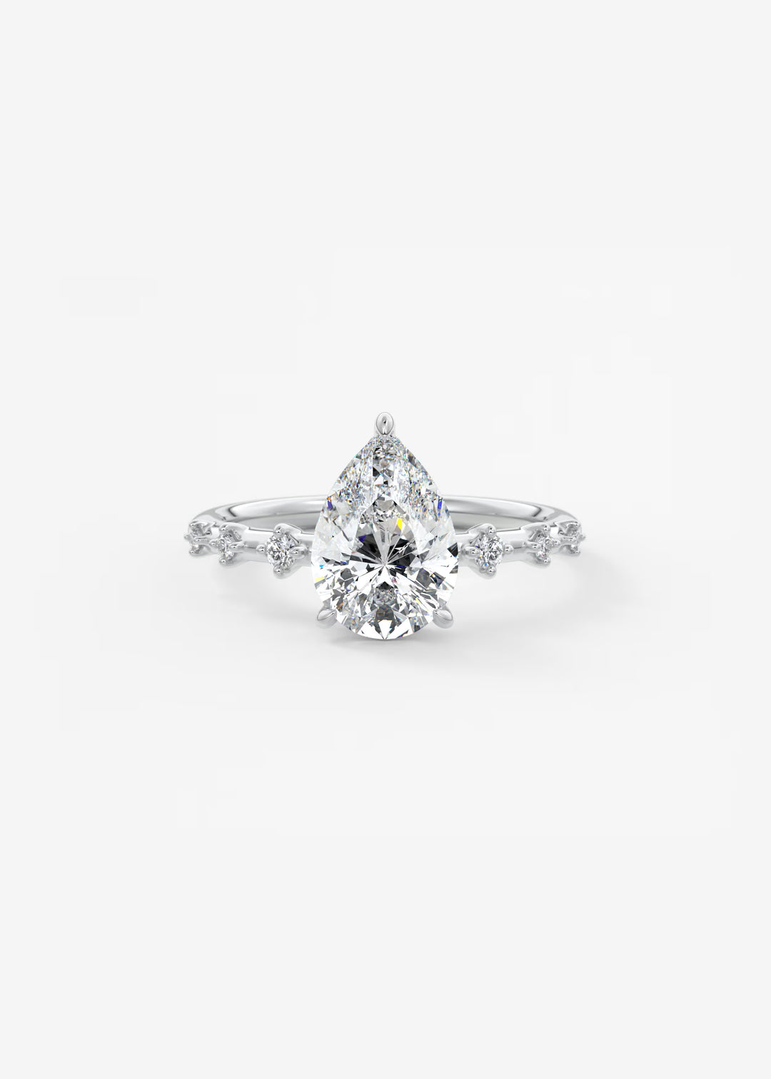 A pear-cut diamond engagement ring with a brilliant center stone and small side diamonds on a white background.#material_white
