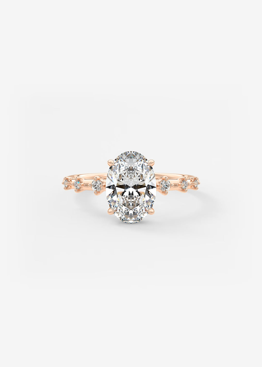 A rose gold engagement ring featuring a large oval-cut center stone and small accent stones along the shoulders, set against a clean white background.#material_rose