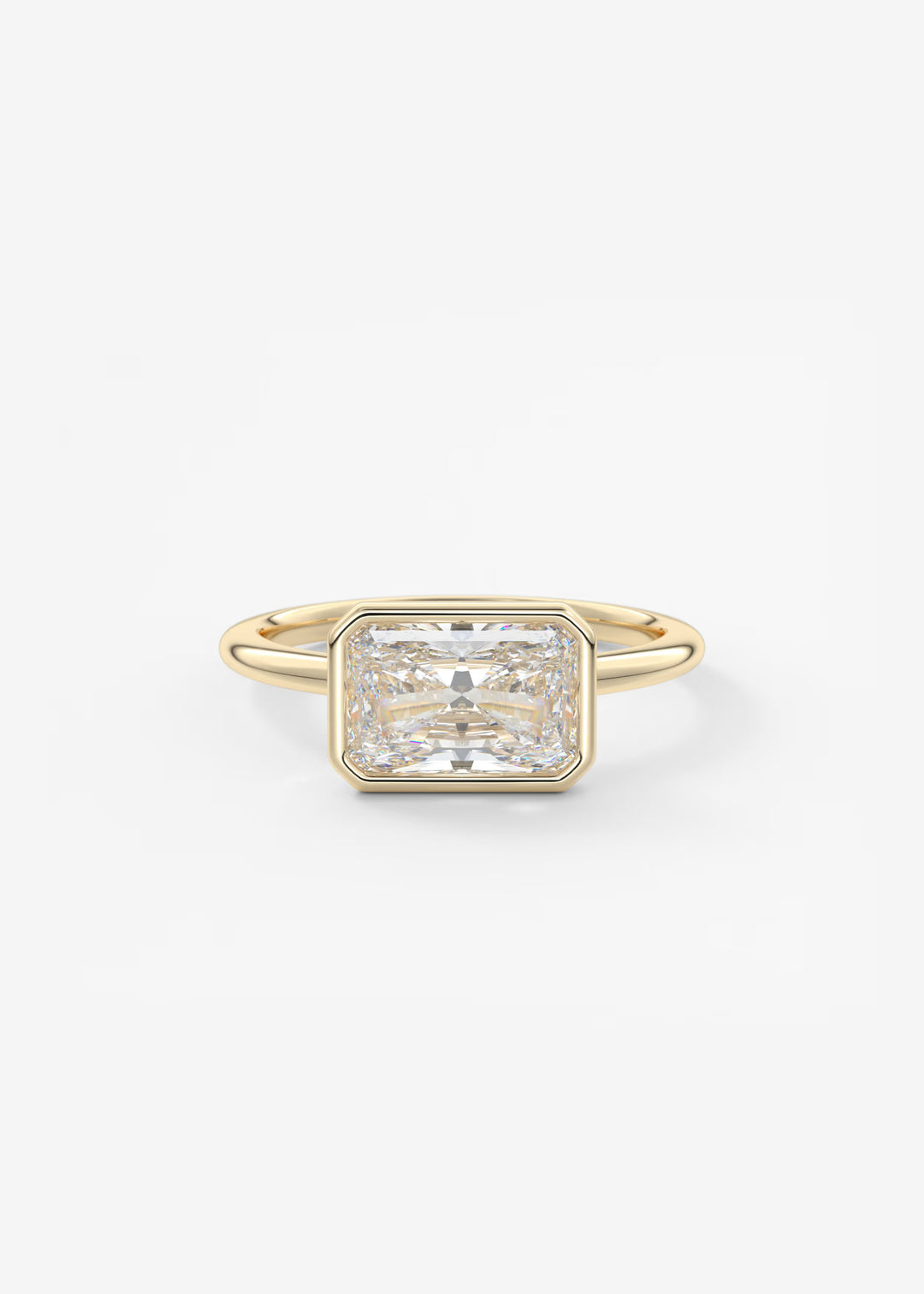 A yellow gold ring featuring a large rectangular emerald-cut diamond center stone, set against a clean white background.#material_gold