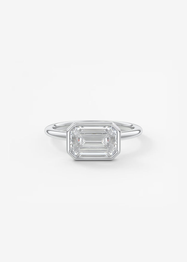 Silver ring with a rectangular gemstone on a white background#material_white