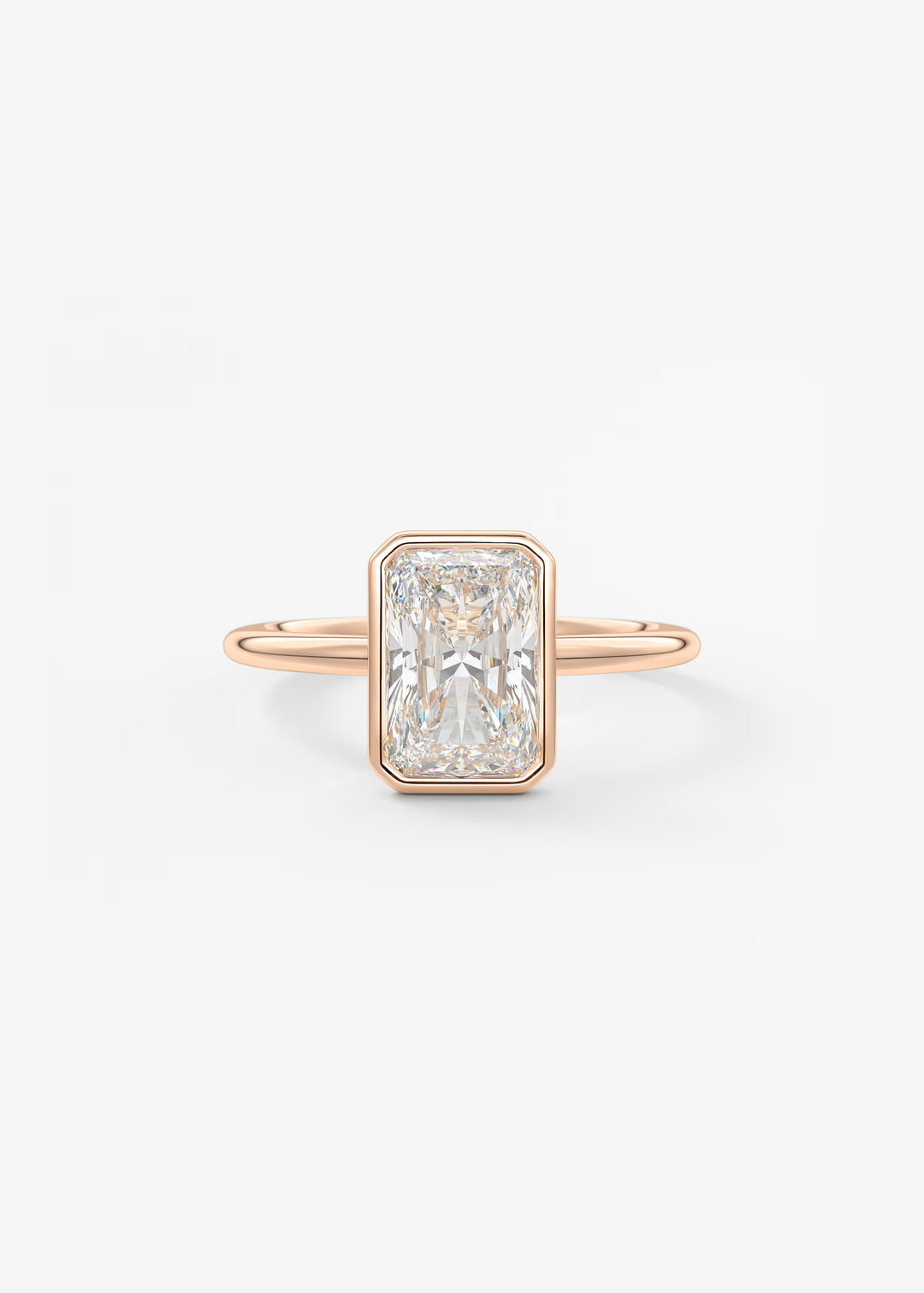 A rectangular emerald-cut diamond ring set in a rose gold band, centered on a clean white background.#material_rose