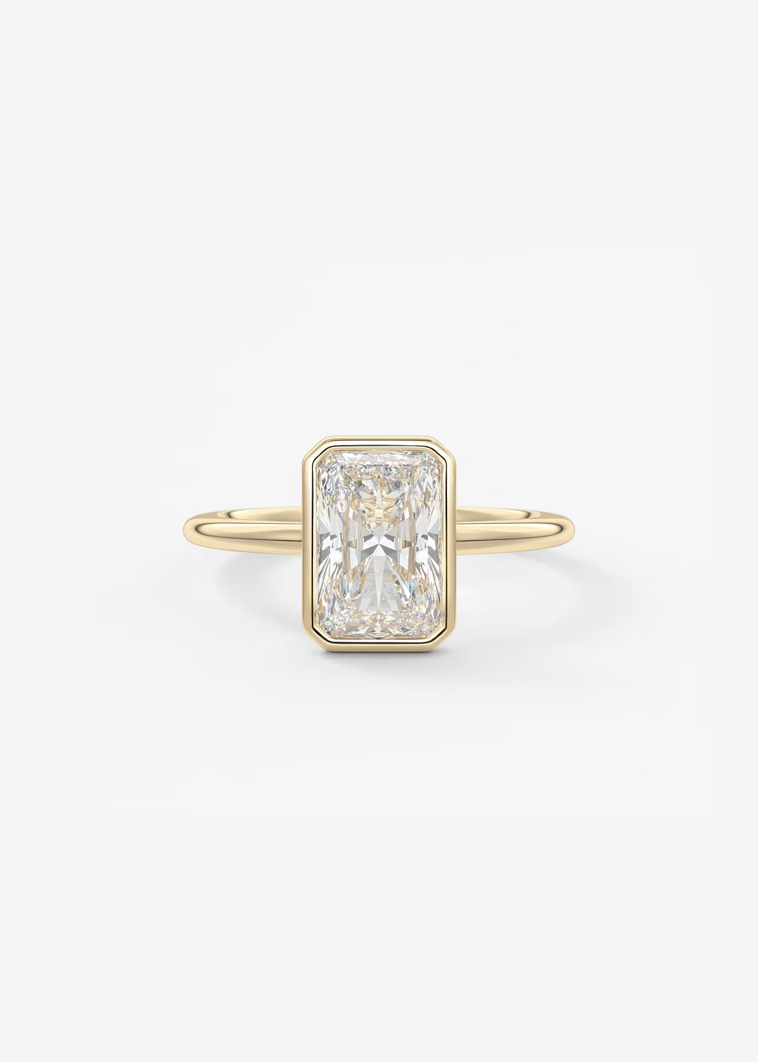 A yellow gold ring featuring a rectangular emerald-cut diamond center stone, set against a clean white background.#material_gold