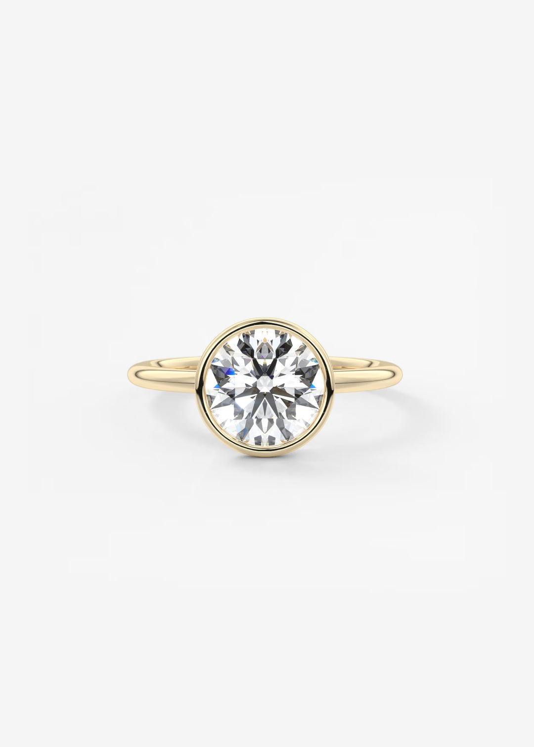 A yellow gold ring featuring a large, round brilliant-cut clear gemstone in a bezel setting, shown against a plain white background.#material_gold
