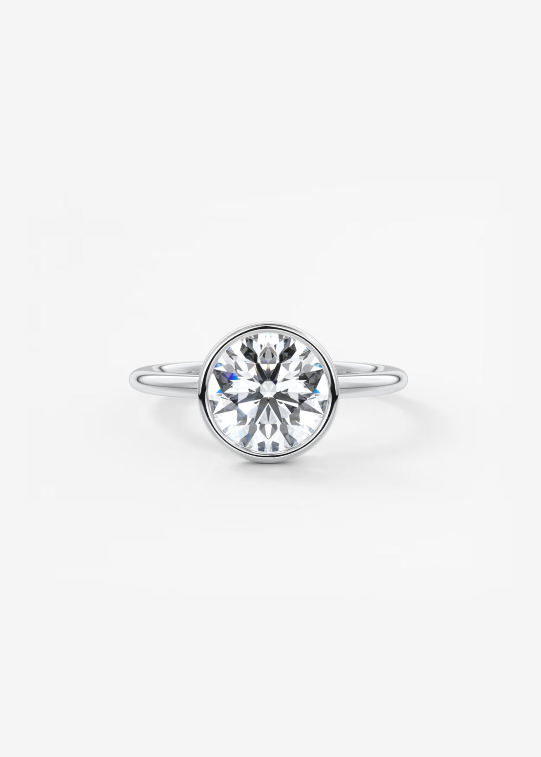 A silver ring featuring a large, round brilliant-cut clear gemstone in a bezel setting, shown against a plain white background.#material_white