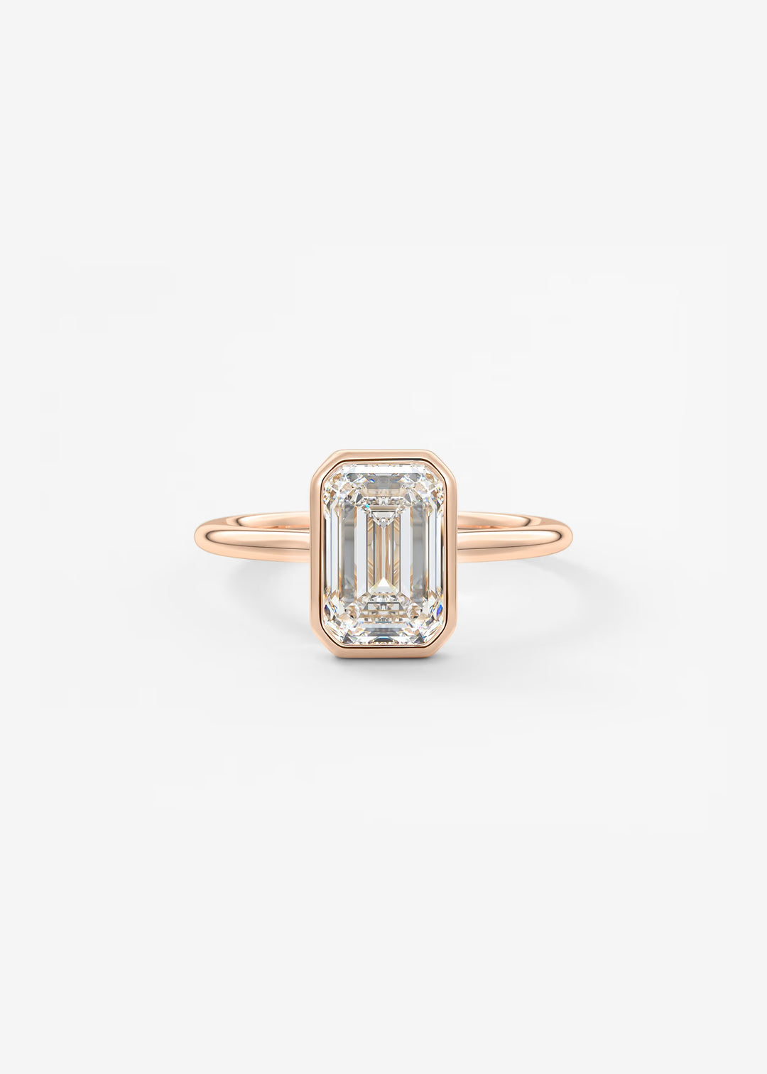 A rose gold ring featuring an emerald-cut clear diamond, set against a clean white background.#material_rose