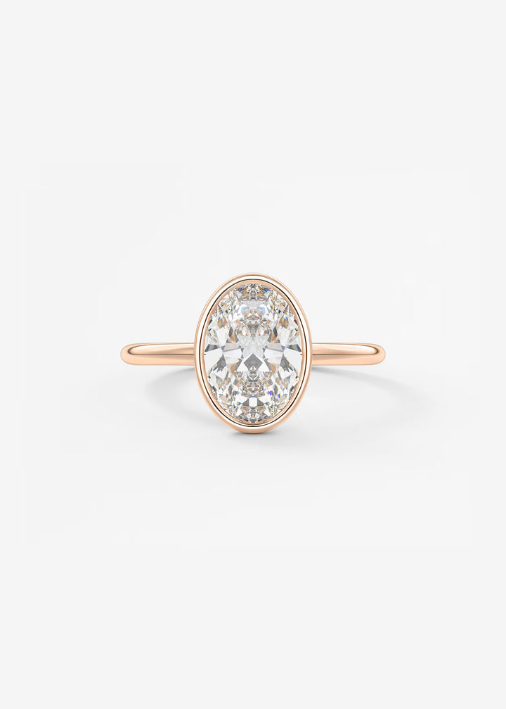 A rose gold ring featuring a large oval-cut clear gemstone in a prong setting, shown against a clean white background.#material_rose
