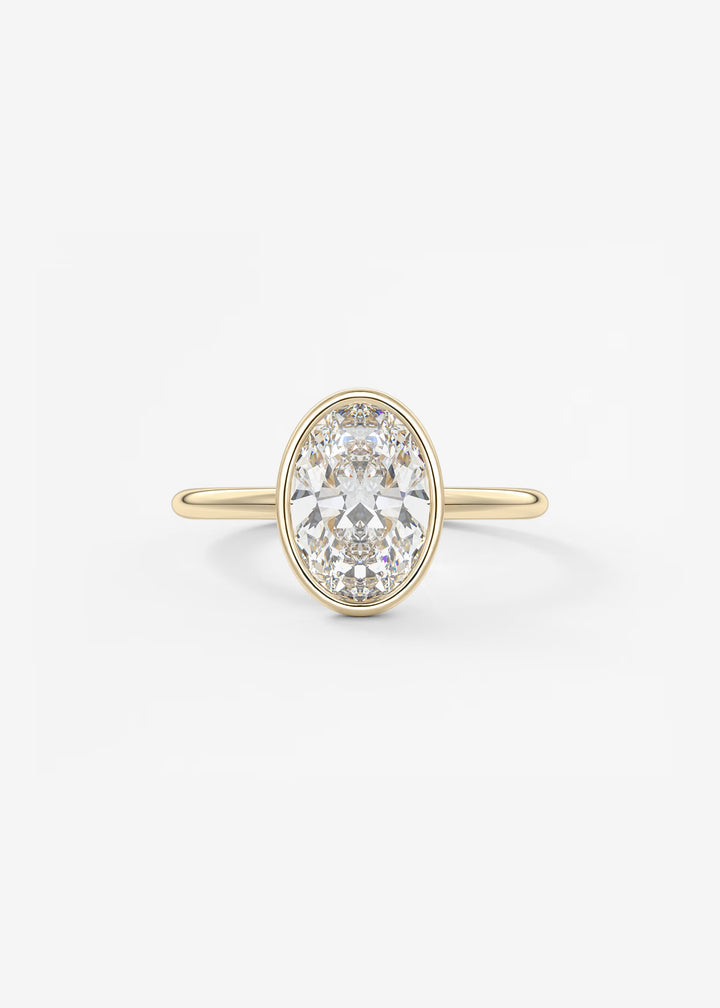 A yellow gold ring featuring a large oval-cut clear gemstone in a prong setting, with a polished band, shown against a plain white background.#material_gold