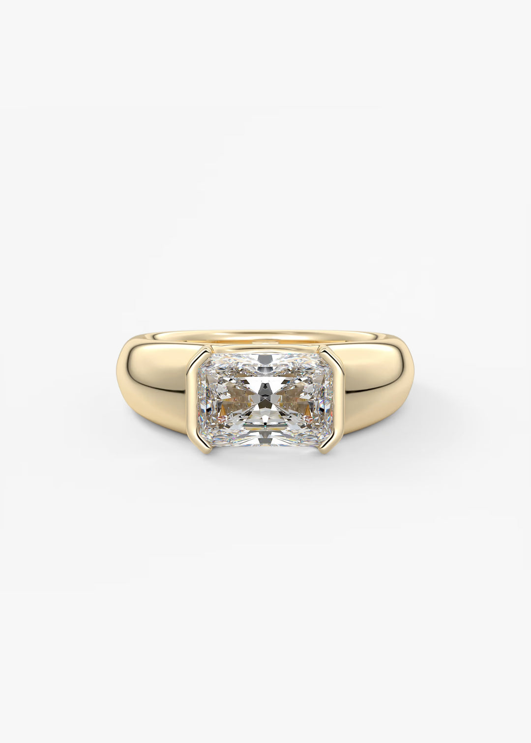 A yellow gold ring featuring a large, radiant-cut clear gemstone in a bezel setting, shown against a plain white background.#material_gold