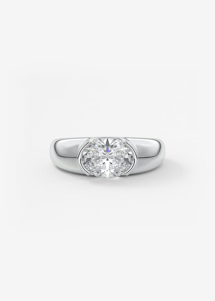A classic solitaire engagement ring featuring a round brilliant-cut diamond set in a polished silver-colored band, presented on a clean white background.#material_white